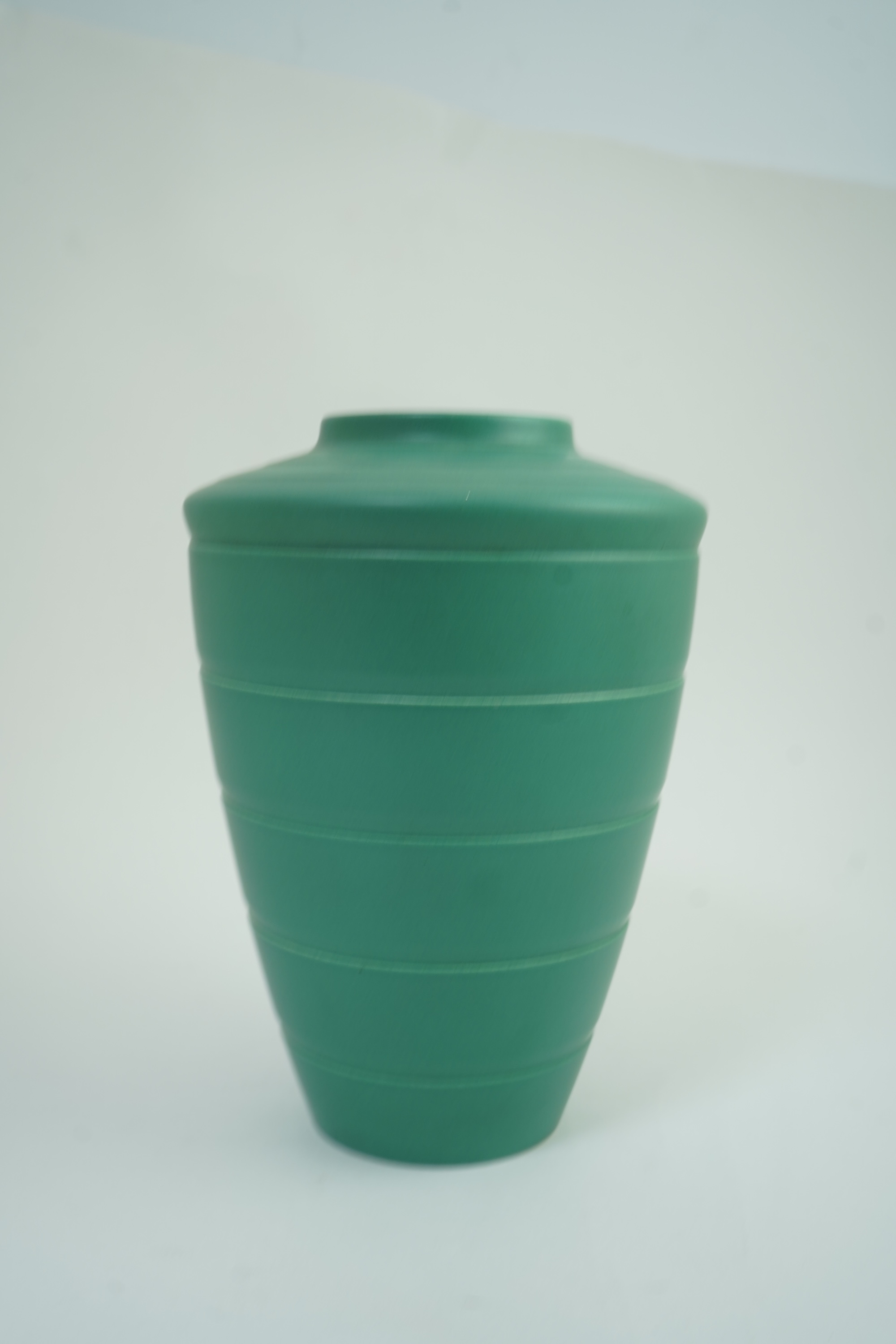 Keith Murray MC RDI FRIBA (New Zealand/British, 1892-1981) for Wedgwood: A matt green glazed tapering vase